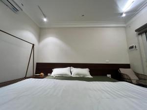 a bedroom with a large white bed in it at Lá house Hà Nội in Dong Anh