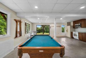 a pool table in the middle of a room at Fawn Hollow Retreat, King bed, game room, BBQ 