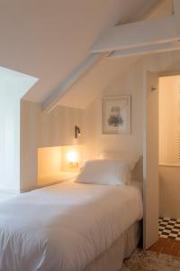 a bedroom with a large white bed in a room at Hôtel Maison Borrèze in Souillac +81 photos
