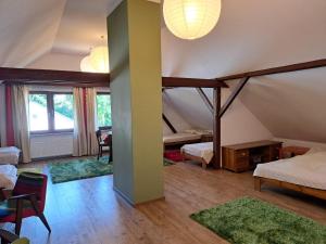 a room with two beds and a room with rugs at Winnica Brochów in Brochów