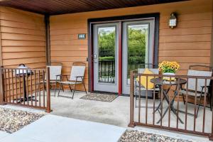 a patio with a table and chairs and a door at UpperDells Riverfront Jacuzzi, Pool and Hot Tub in Wisconsin Dells