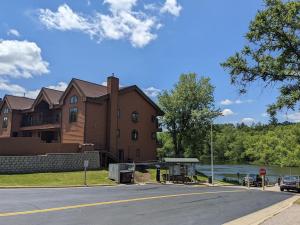 a building on the side of a road next to a river at UpperDells Riverfront Jacuzzi, Pool and Hot Tub in Wisconsin Dells