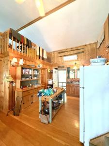 a kitchen with wooden cabinets and a white refrigerator at Sandy Beach, Private Dock & Boat Access in Meredith