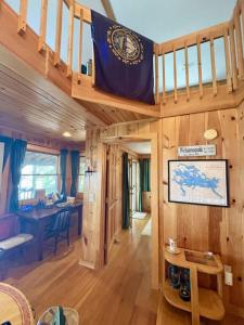 a wooden cabin with a flag on the stairs at Sandy Beach, Private Dock & Boat Access in Meredith