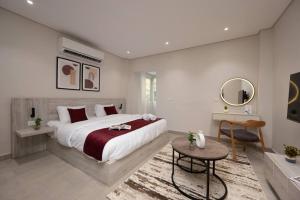 a bedroom with a large bed and a table at Book Today & save 88 Escape by Spacey Pool-Modern-Prime spot #73- in Cairo +18 photos