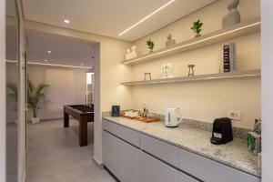 a kitchen with a counter and a desk in a room at Book Today & save 88 Escape by Spacey Pool-Modern-Prime spot #73- in Cairo