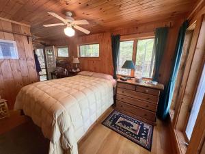 a bedroom with a bed and a ceiling fan at Sandy Beach, Private Dock & Boat Access in Meredith