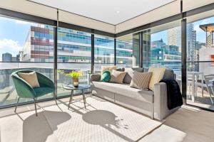 a living room with a couch and a table at Serrata - 2B2B Docklands Apt Parking Available in Melbourne