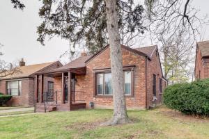 a brick house with a tree in front of it at Detroit Retreat with Gazebo Fire Pits and Charcoal Grill in Detroit