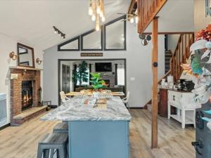 a kitchen and living room with a table and a fireplace at Memorabile Getaway Fire-Pit and Entrainment Area in Long Pond