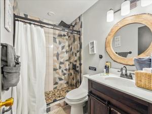 a bathroom with a sink and a toilet and a mirror at Memorabile Getaway Fire-Pit and Entrainment Area in Long Pond +42 photos
