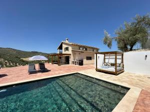 a villa with a swimming pool and a house at Casa Manuela in Montefrío