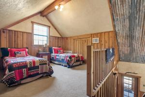 a room with two beds and a crib in it at SisterCreek Ranch - Other Cabin in Boerne