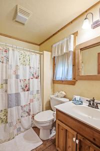 a bathroom with a toilet and a sink at SisterCreek Ranch - Other Cabin in Boerne