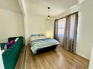 En eller flere senge i et værelse på Gizmo's Garden Cottage