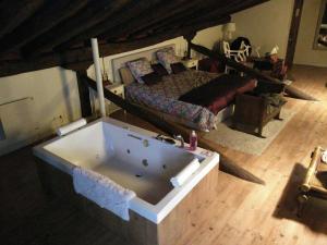 a large bath tub in a bedroom with a bed at Casa Rural Lakoak in Garínoain