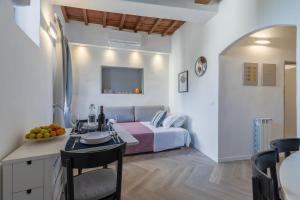 a hotel room with a bed and a table and chairs at Bijoux Suite near Boboli Gardens in Florence
