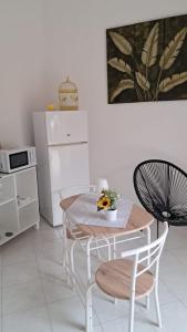 a kitchen with a table and chairs in a kitchen at White House in Sassari