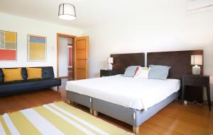 a bedroom with a large bed and a couch at Quinta da Corticeira in Elvas +42 photos