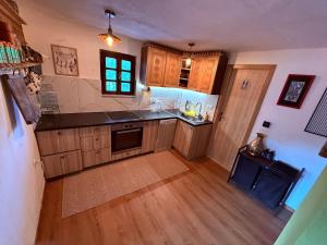 a kitchen with wooden cabinets and a counter top at Cabin Rujište in Padežina