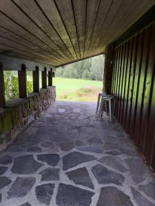 a patio with a table and a chair in a building at Holiday Home Garnås in Nesbyen