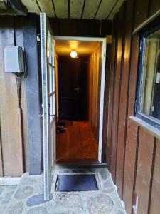 a hallway of a house with a door and a window at Holiday Home Garnås in Nesbyen