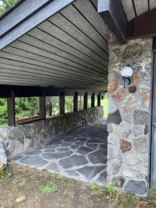 a stone walkway under a wooden bridge at Holiday Home Garnås in Nesbyen