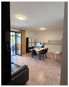 a living room with a dining room table and chairs at Basilicata Host to Host - Maranna Apartment in Policoro