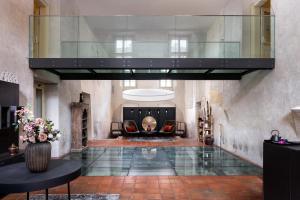 a living room with a glass elevator in a building at Mandarin Oriental, Prague in Prague +127 photos