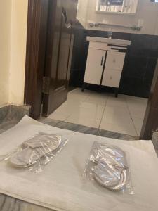 two pieces of tin foil on a bed in a kitchen at ROYALE VISTA by MIR in Islamabad