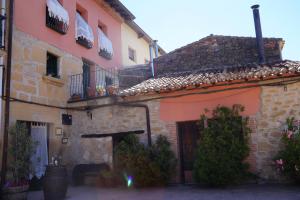 an old stone building with a door and a balcony at Carpe Diem in Navaridas