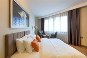 a hotel room with a bed with pillows and a window at GRANDROYAL HOTEL in Gümüşyaka +31 photos