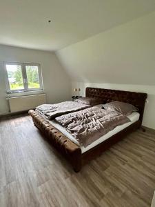 a bedroom with a large bed in a room at Seensucht Das Haus am Steg in Fürstenberg-Havel