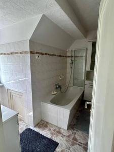 a white bathroom with a tub and a shower at Seensucht Das Haus am Steg in Fürstenberg-Havel +22 photos