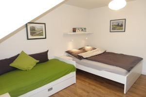 a bedroom with two beds in a attic at Haus Karla in Langeoog