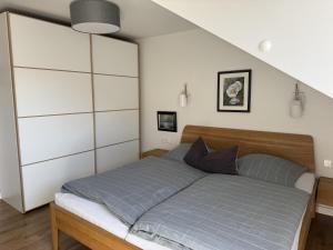 a bedroom with a large bed with blue sheets at Haus Karla in Langeoog