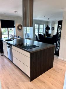 a kitchen with a large island with a counter top at Romslig hus med jacuzzi, spillrom og stor terrasse in Fredrikstad