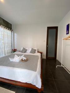 a bedroom with a bed with a plate on it at baan in kan homestay&cafe kanchanaburi city in Kanchanaburi +20 photos