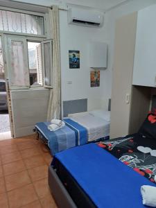 a bedroom with two beds and a window at La casetta di Ciacione in Naples +34 photos