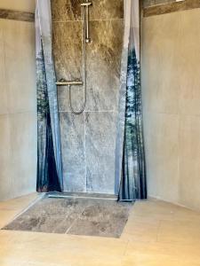 a shower in a bathroom with a shower curtain at Schlossblick Komfort Apartment in Weilburg