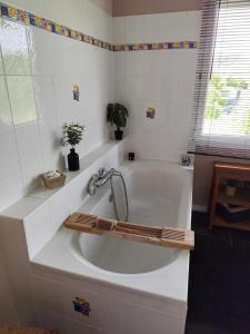 a white bath tub with a faucet in a bathroom at Chez Lily et Fred in Châlons-en-Champagne +26 photos