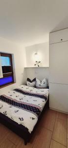 a bedroom with a bed with pillows on it at Costa Blanca Międzyzdroje - Holiday Home in Międzyzdroje