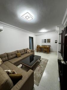 ein Wohnzimmer mit Sofa und Tisch in der Unterkunft Kantoui apartment in Kasnadar