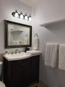 a bathroom with a sink and a mirror and towels at Lovely Provo Oasis in Provo +46 photos