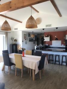 a kitchen and dining room with a table and chairs at Maison proche Bayonne in Urcuit
