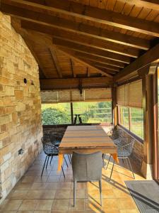 a dining room with a wooden table and chairs at Casa La Escollera in Cangas de Onís