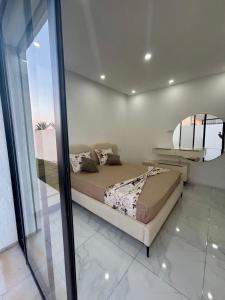 a bedroom with a bed in a room at Magnifique Villa Kayo, Djerba in Arkou +20 photos