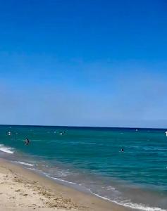 a group of people in the water at the beach at À mi-chemin in Claira