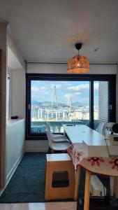 a room with a large window with a view of a city at Santiago Ocean View House in Busan