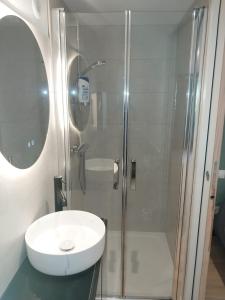 a bathroom with a white sink and a shower at La belle étape in Montmélas-Saint-Sorlin